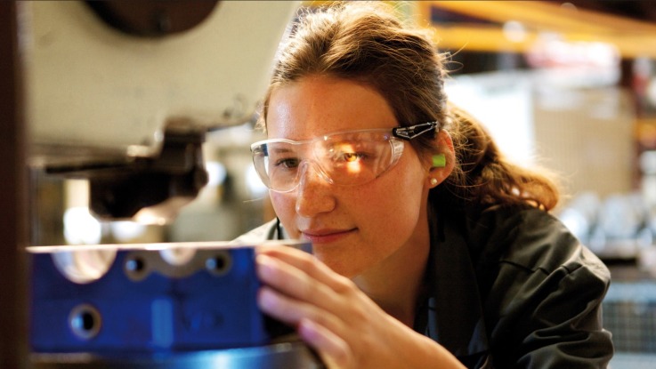 A trainee setting up a machine