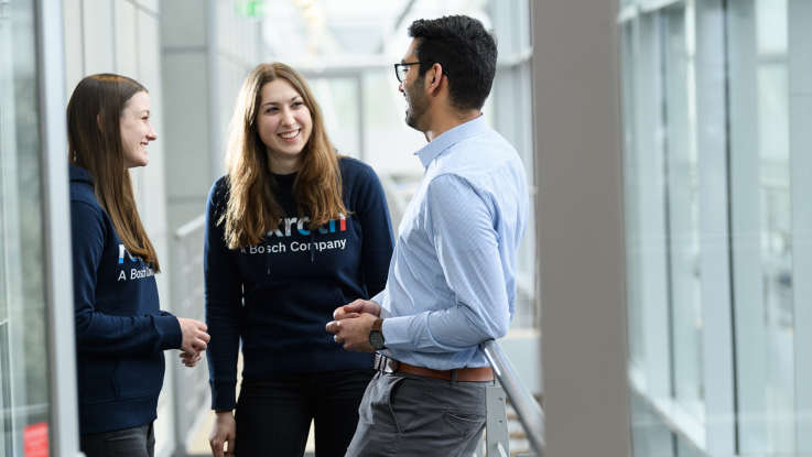 Two students talking to their mentor