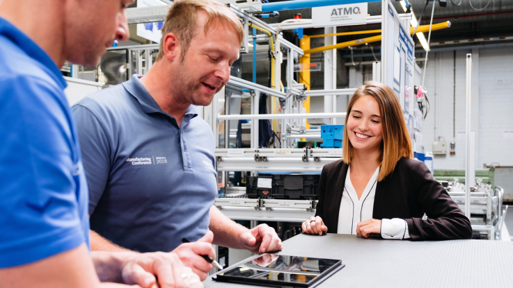 Students having a discussion in the production environment