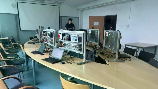 PLC Box training kits placed on tables in the room.