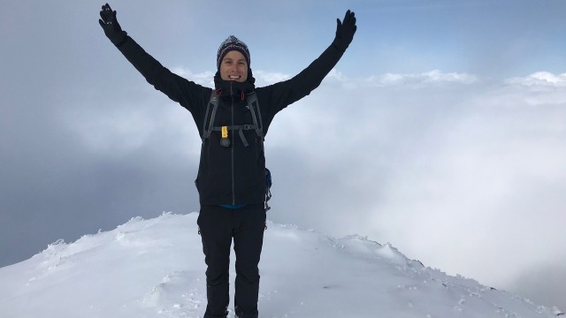 Pascal Wuertz while in the Bosch Rexroth graduate program standing on top of snow covered mountain
