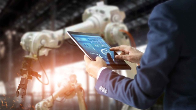 Person with tablet in factory