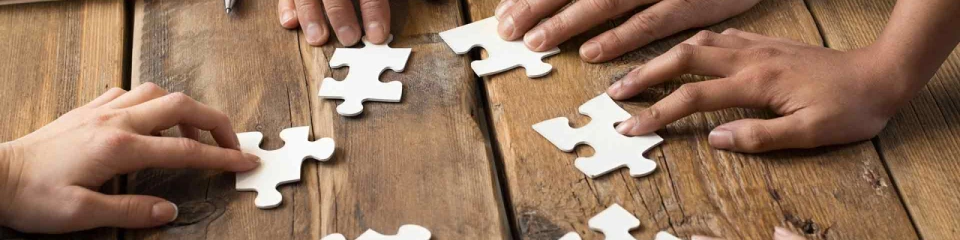 Hands collaborating on puzzle
