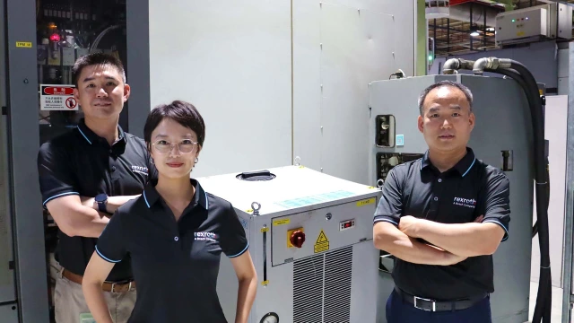 Three employees standing in the production facility