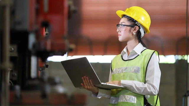 factory operator with laptop