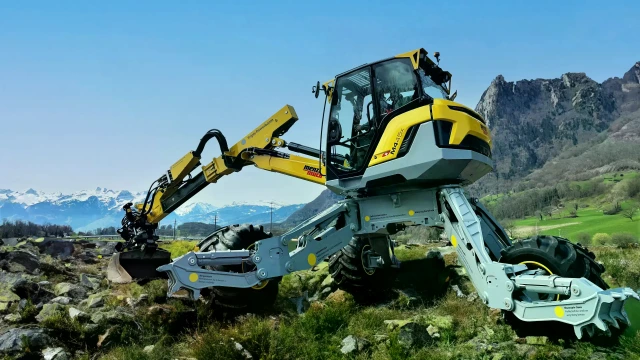 yellow-grey Menzi Muck M4x walking excavator in the mountains