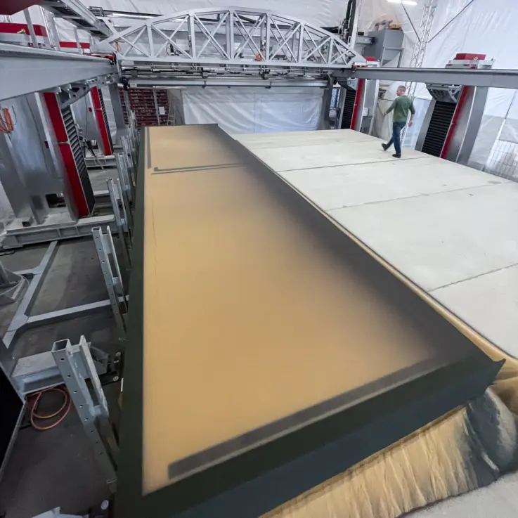 A person walks across the world's largest 3D printer, the voxeljet VX9000