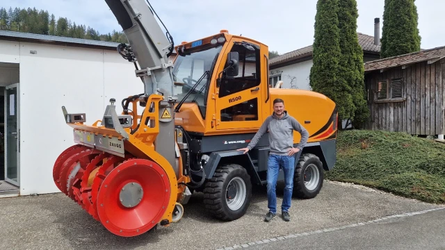 Simon Brechbühler in front of the telematics-enabled and IOT-enabled Rolba 500 self-propelled snow cutter blower