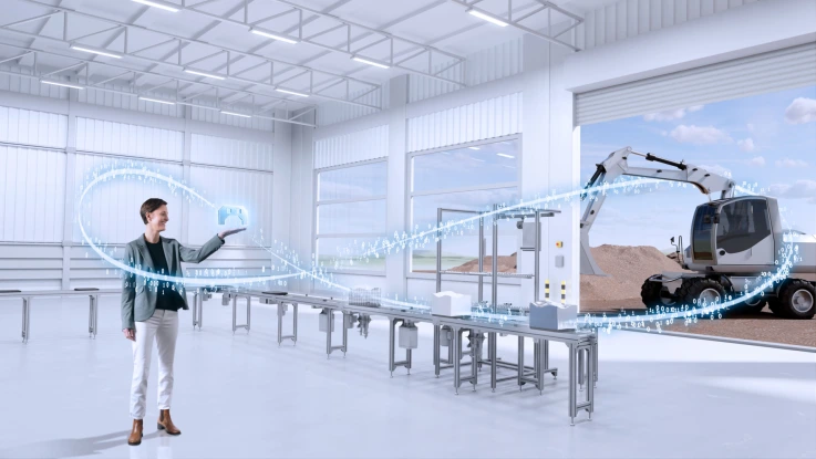 Woman standing in front of factory machine.