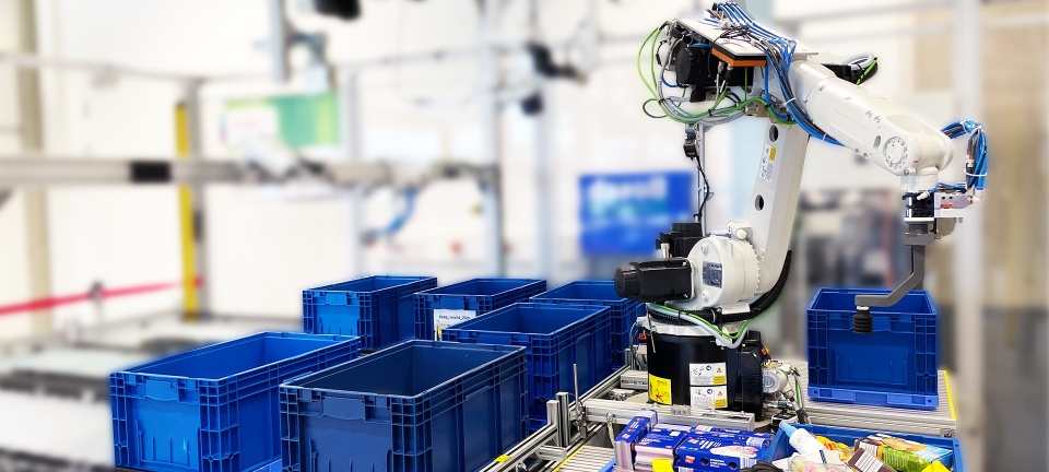 Industrial robot is picking and placing random items in multiple order bins which are placed on conveyor belts. 