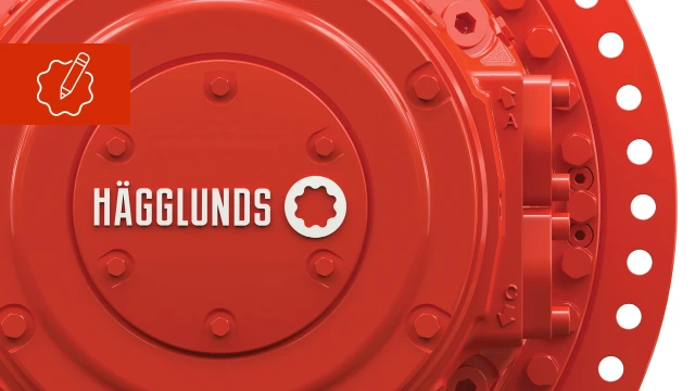 Rød hydraulikmotor med hvidt Hägglunds-logo