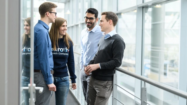 Four employees in the hallway