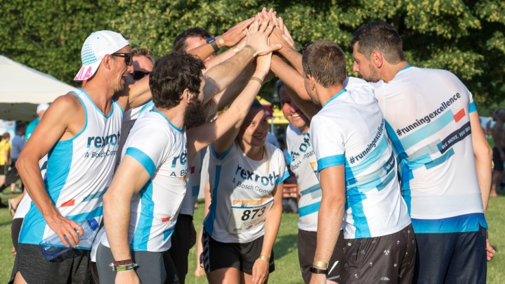 group of marathon runners clap each other