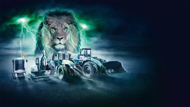 Mobile Arbeitsmaschinen vor dem Gesicht eines Löwen.