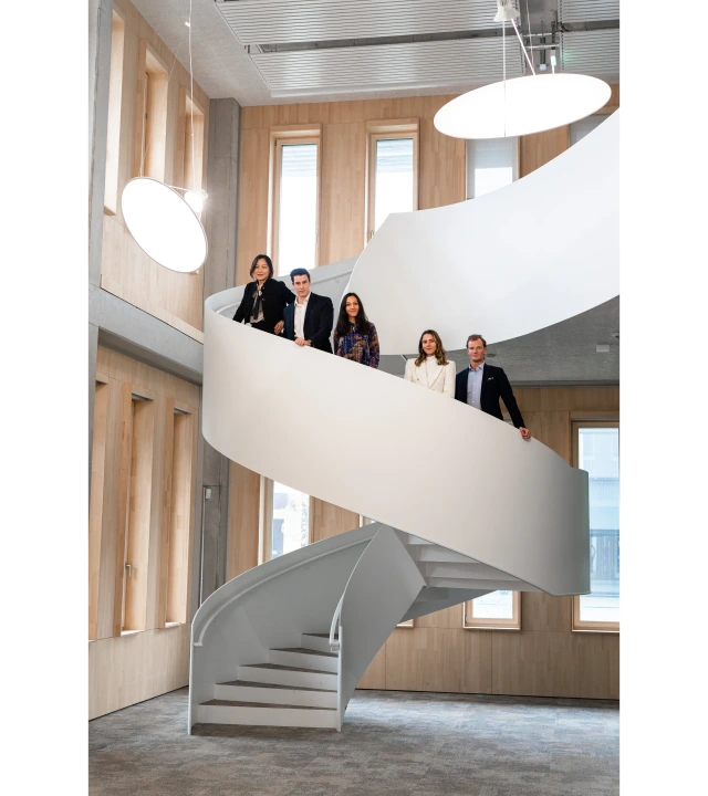 The movers standing on a spiral staircase.