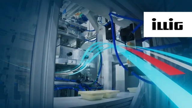 Thermoforming machine processing trays with the ILLIG logo.