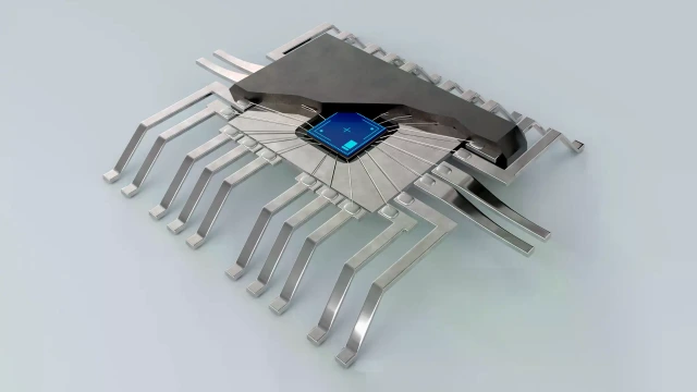 Ein stilisierter grauer Mikrochip mit metallischen Pins und einem kleinen hellblauen Quadrat in der Mitte.