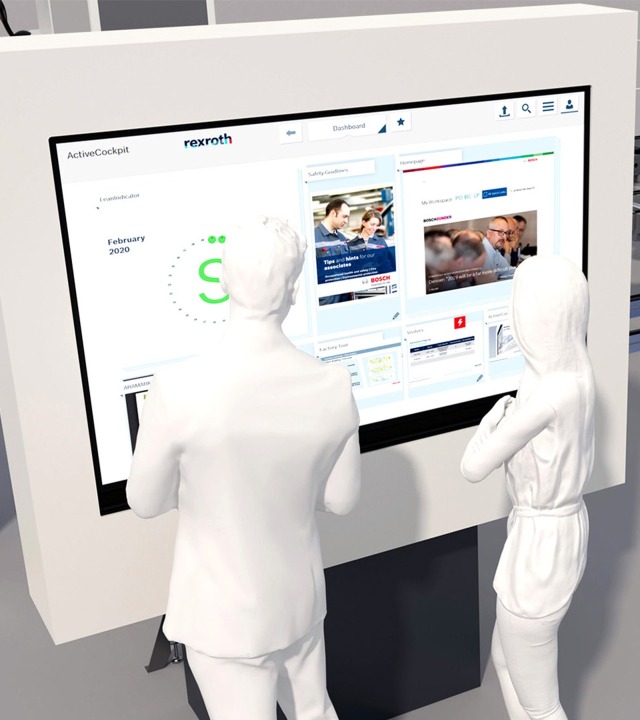 Two people standing in front of  ActiveCockpit from Bosch Rexroth