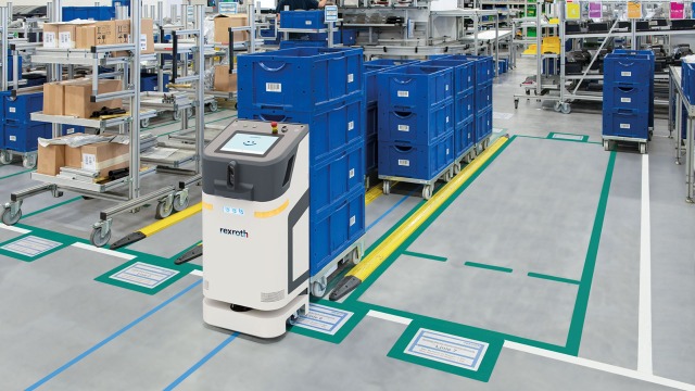 Active Shuttle autonomous mobile robot from Bosch Rexroth lifts up a dolly with 4 small load carriers