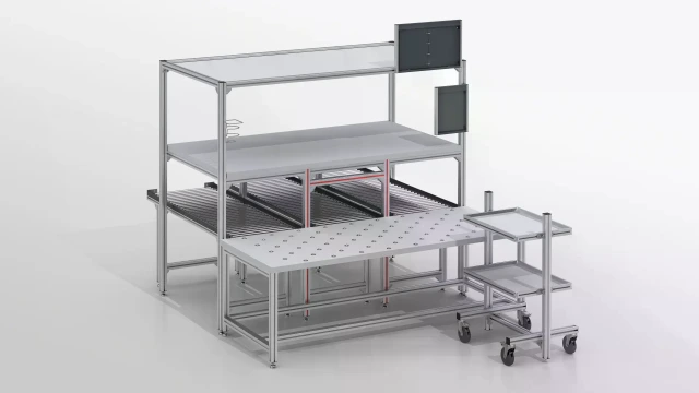 Workbench for order picking with integrated point rollers for moving the material. In the foreground, a material shuttle with 2 material levels. In the background, a middle and upper level on an aluminum frame.