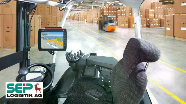 Warehouse with two forklifts, a monitor next to the steering wheel, and the SEP Logistik AG logo.