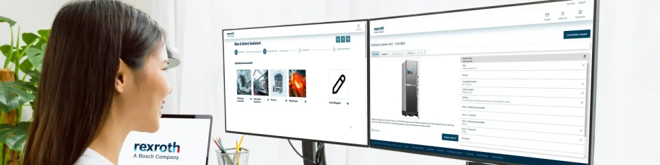 Frau sitzt vor zwei Bildschirmen und konfiguriert ein Hydraulikaggregat