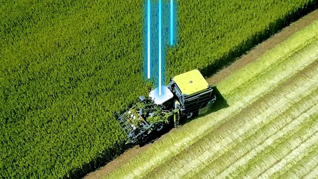 Combine harvester in the field receiving a software update over the air 