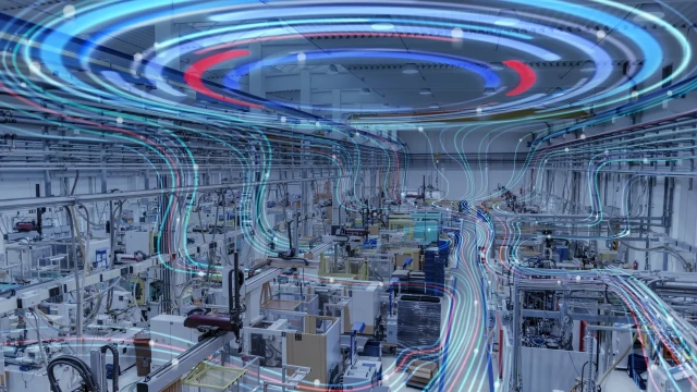 Modern factory floor with interconnected machinery and glowing lines representing data flow and automation.