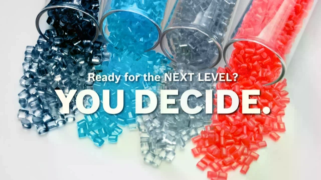 Probówki z kolorowymi granulkami z tworzywa sztucznego. Tekst: Ready for the NEXT LEVEL? YOU DECIDE.