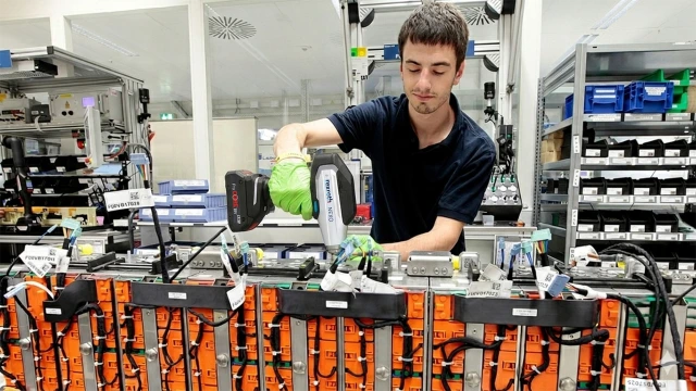 Image of a cordless nutrunner NEXO in use during complex battery assembly
