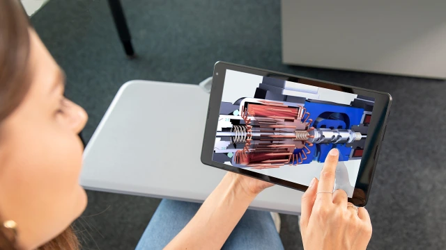 A woman holding a tablet with the company's product displayed
